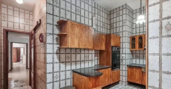 The kitchen has period furniture and tiles. 